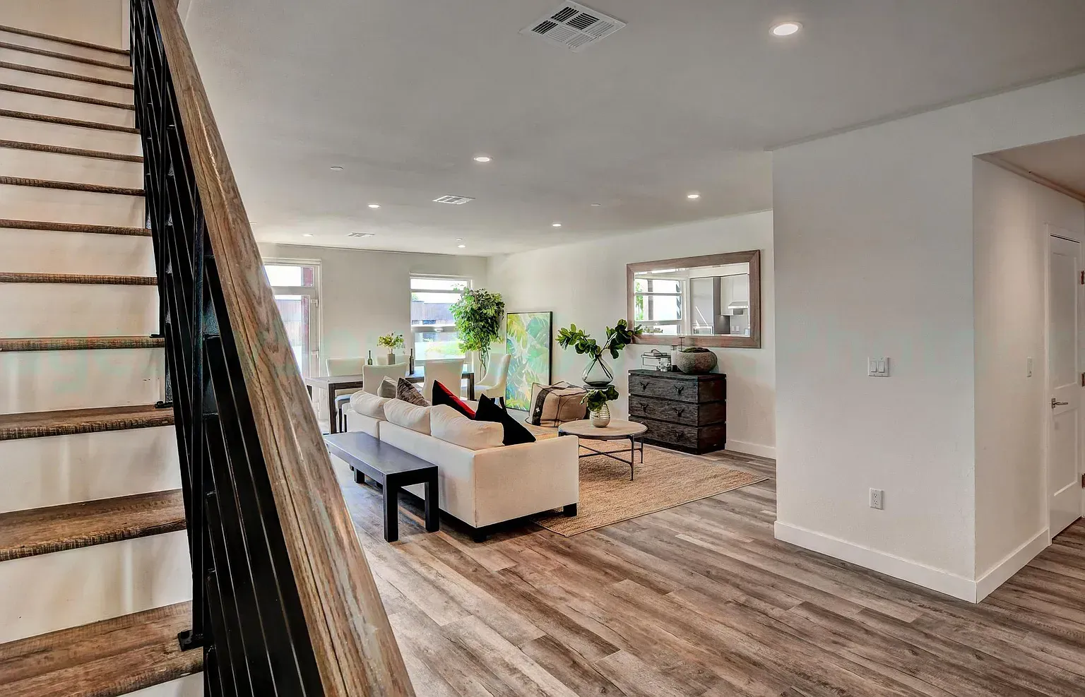 Modern apartment living room with large windows and natural light By Stoneridge Management Partners
