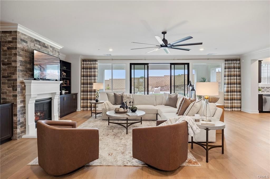 Modern living room with sectional sofa, fireplace, large windows, and ocean view
