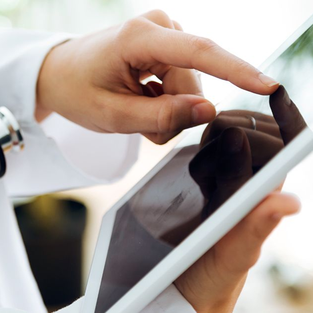 Hand using a tablet, tapping the touchscreen