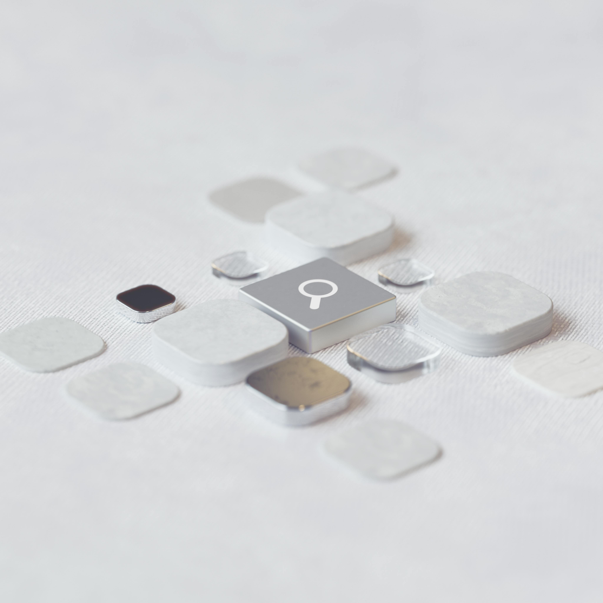 Abstract white and gray 3D tiles with a central magnifying glass icon on a light background