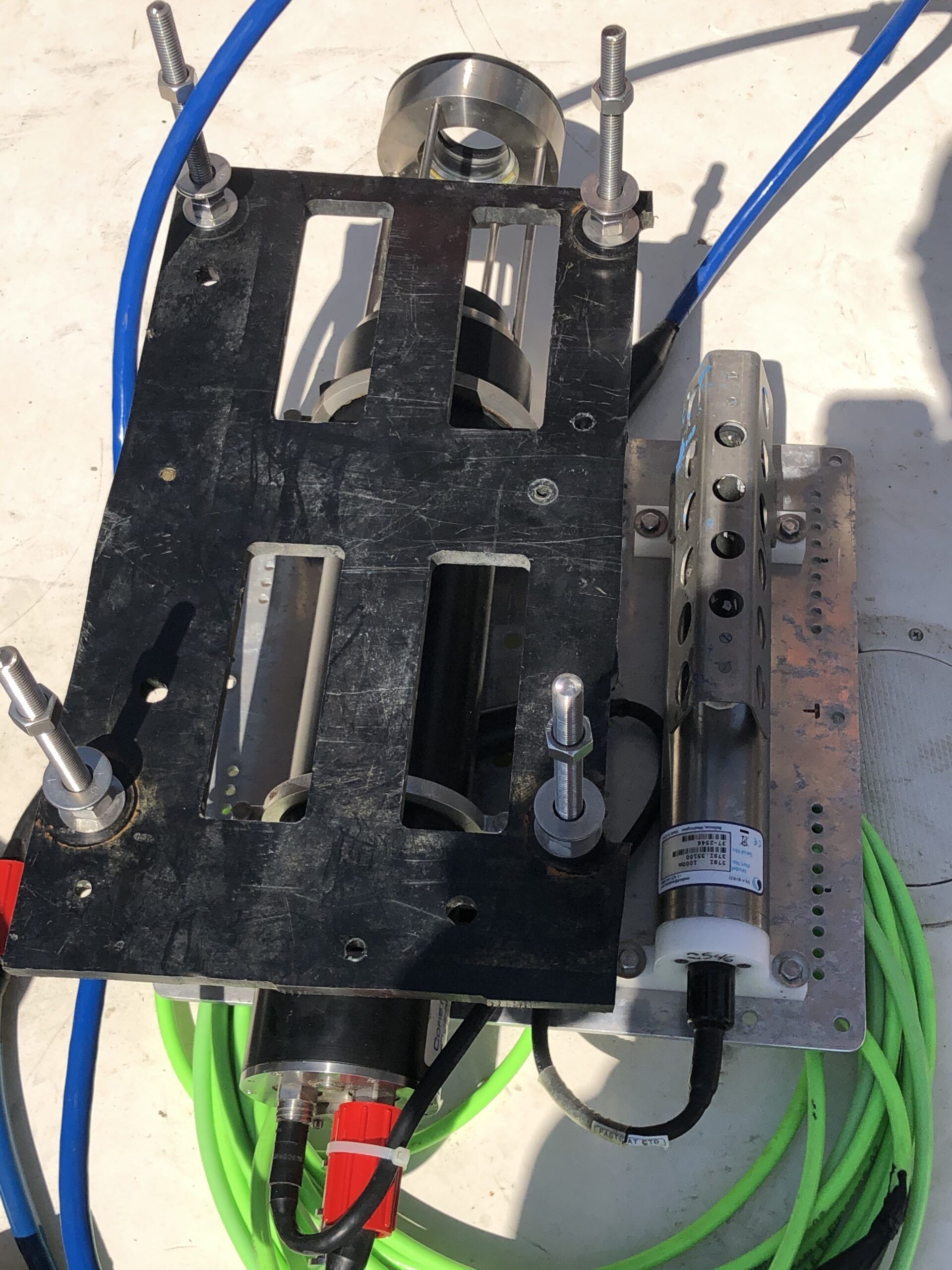 A machine with a green cable attached to it