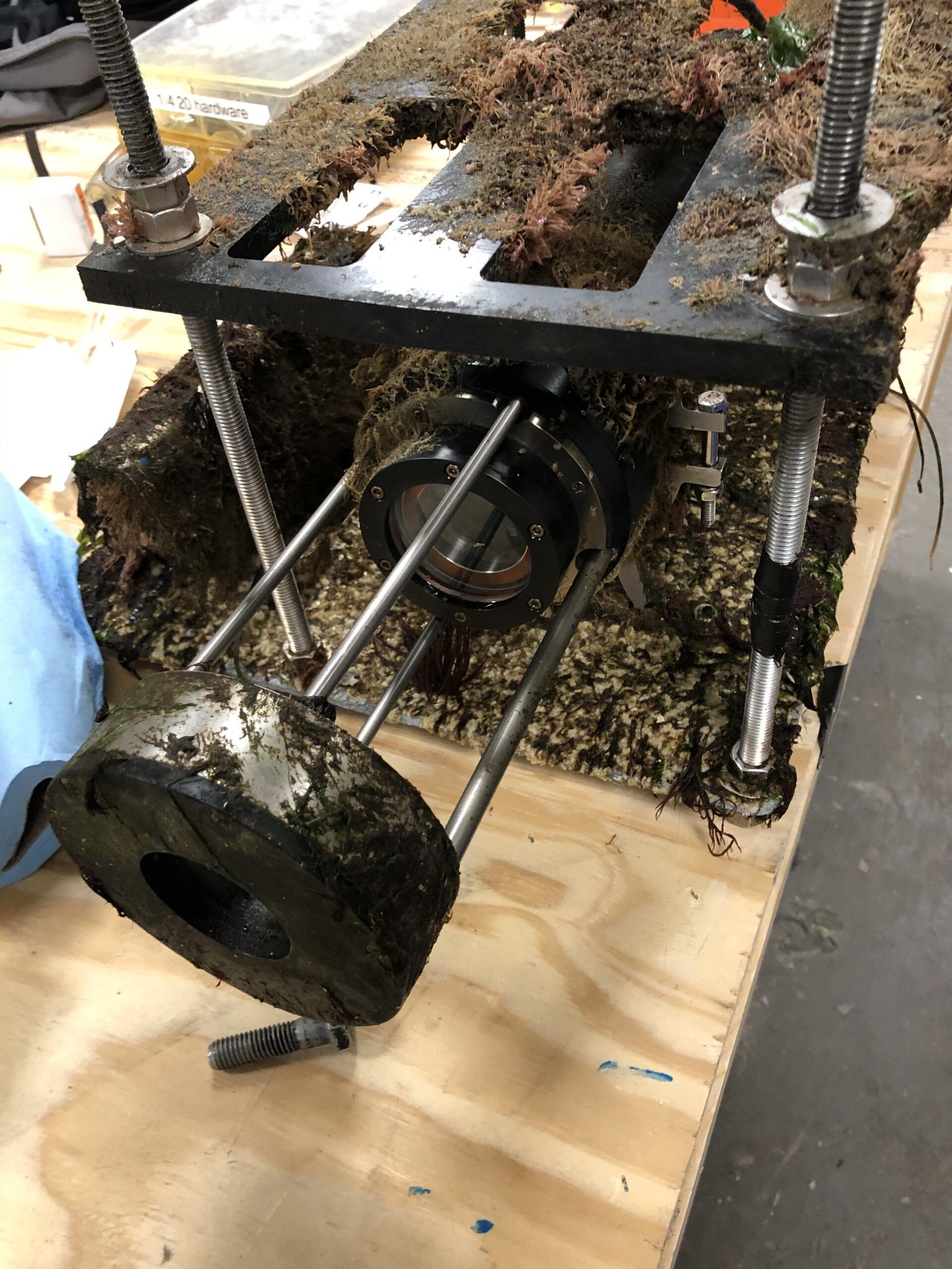 A piece of metal is sitting on top of a wooden table.