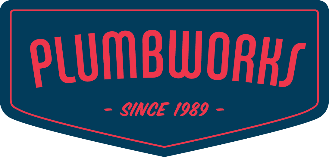 Logo for Plumbworks, a plumbing company, with red text on a blue shield-shaped background. 