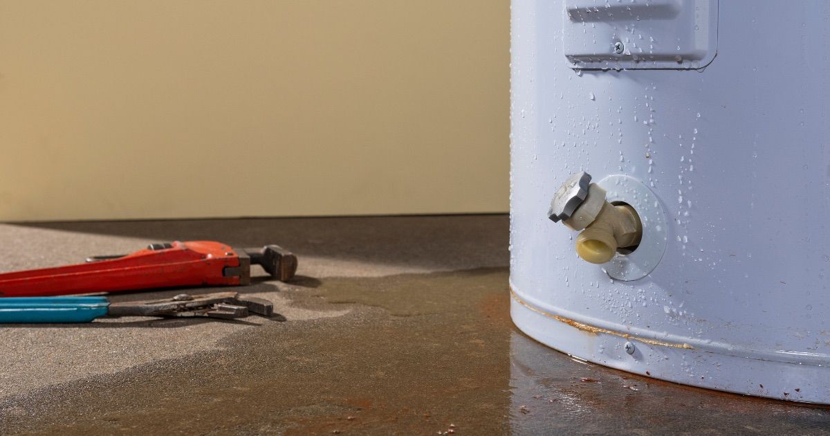 Broken water heater with water spilled on the floor