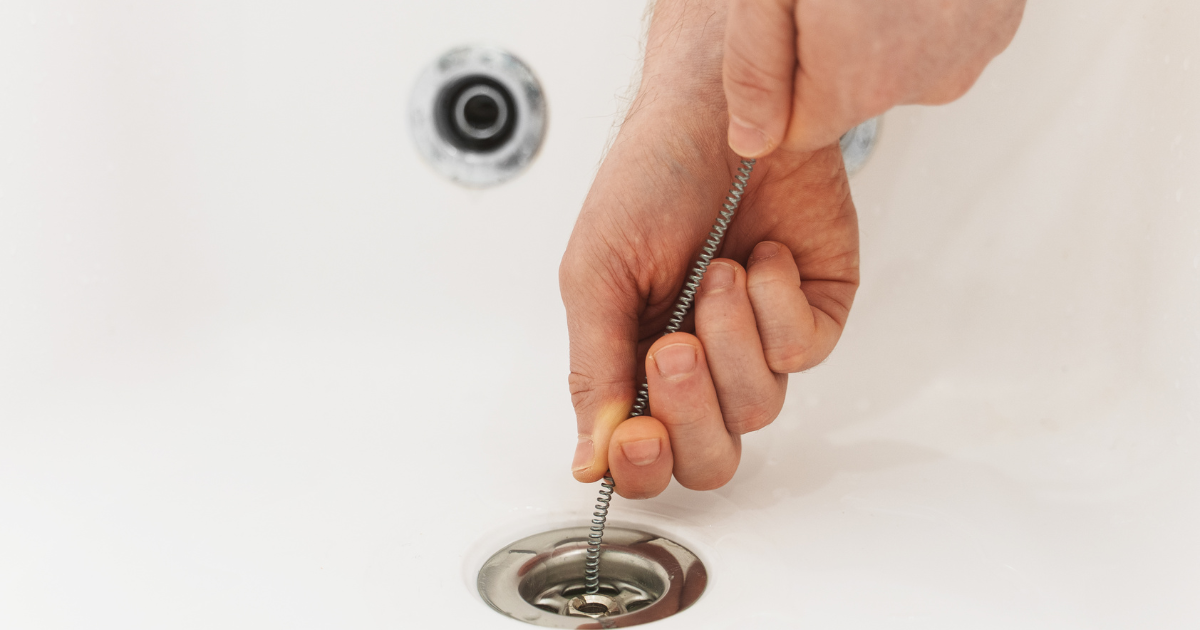 Hand snaking a drain