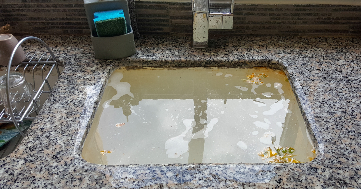 Clogged sink full of dirty water