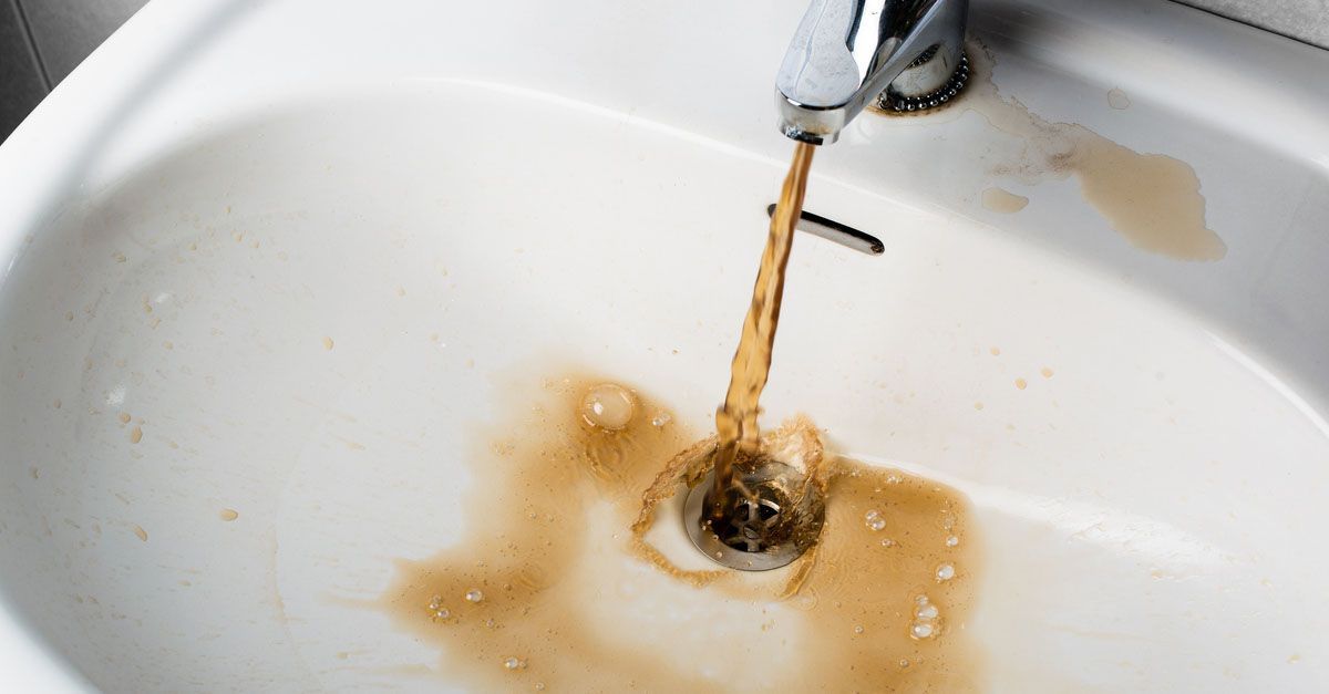Sink with brown water coming out of it