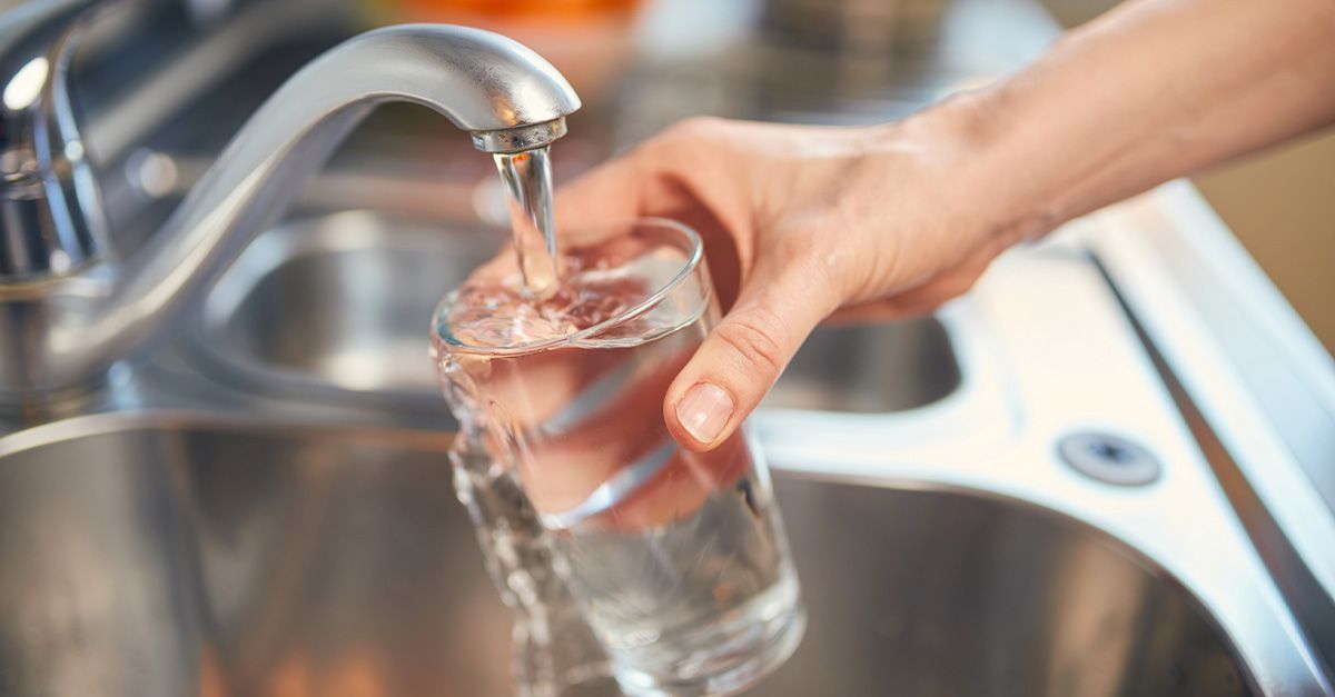 Water is being poured out of a sink as tap water.