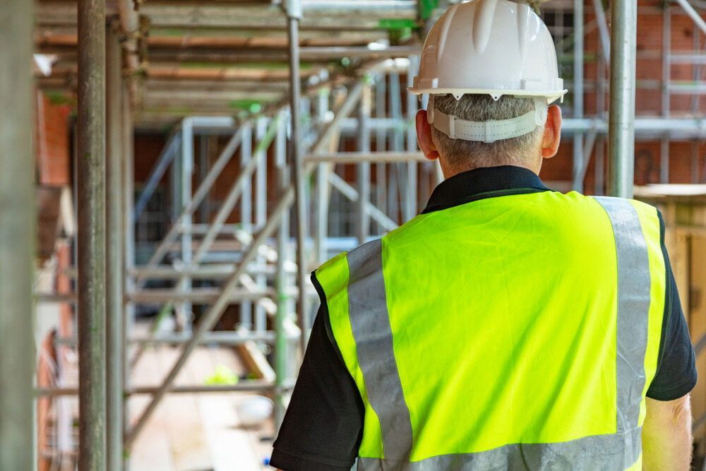 Construction Worker in Yellow Vest and White Hard Hat — KNG Roofing And Construction in Darwin, NT