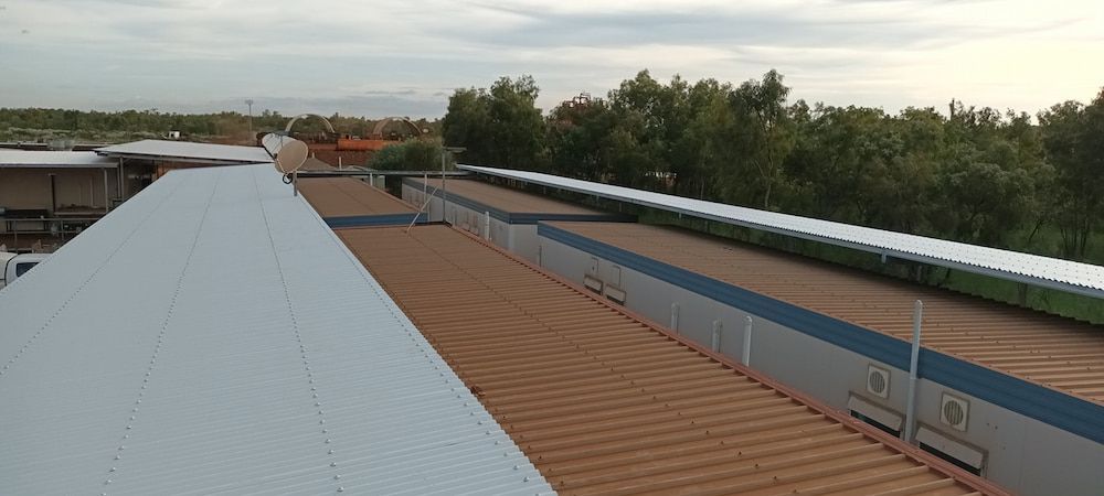 A Wide Shot of Rooftops of Buildings. There Are Trees — KNG Roofing And Construction in Darwin, NT