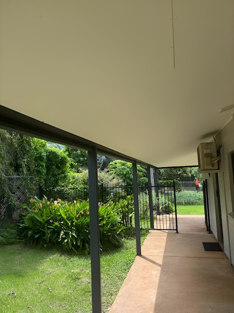 A Covered Patio With a Concrete Floor, Leading to a Gated Backyard — KNG Roofing And Construction in Humpty Doo, NT