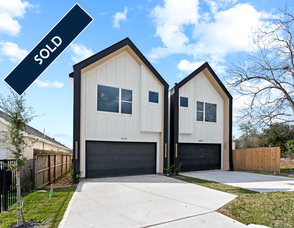 Two modern white houses with black trim and garage doors, 