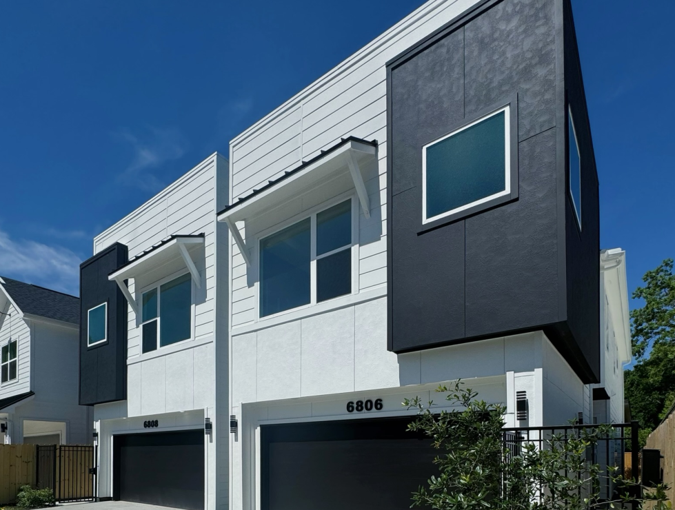 Modern two-story townhouses in white and gray with a 