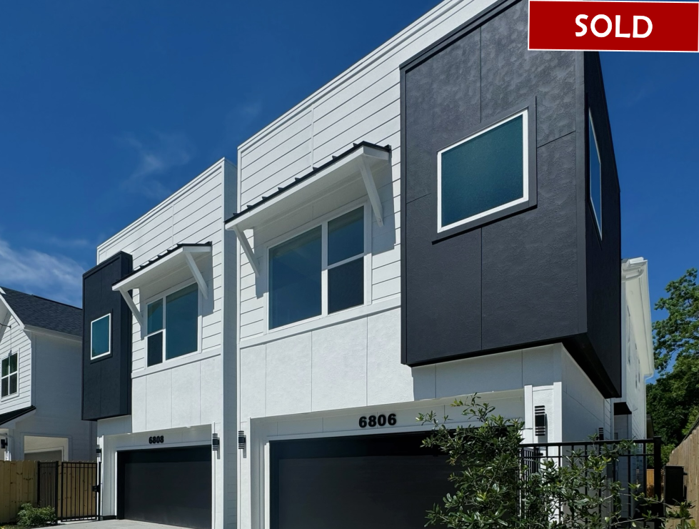 Modern two-story townhouses in white and gray with a 