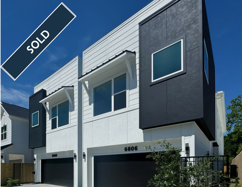 Modern two-story townhouses in white and gray with a 