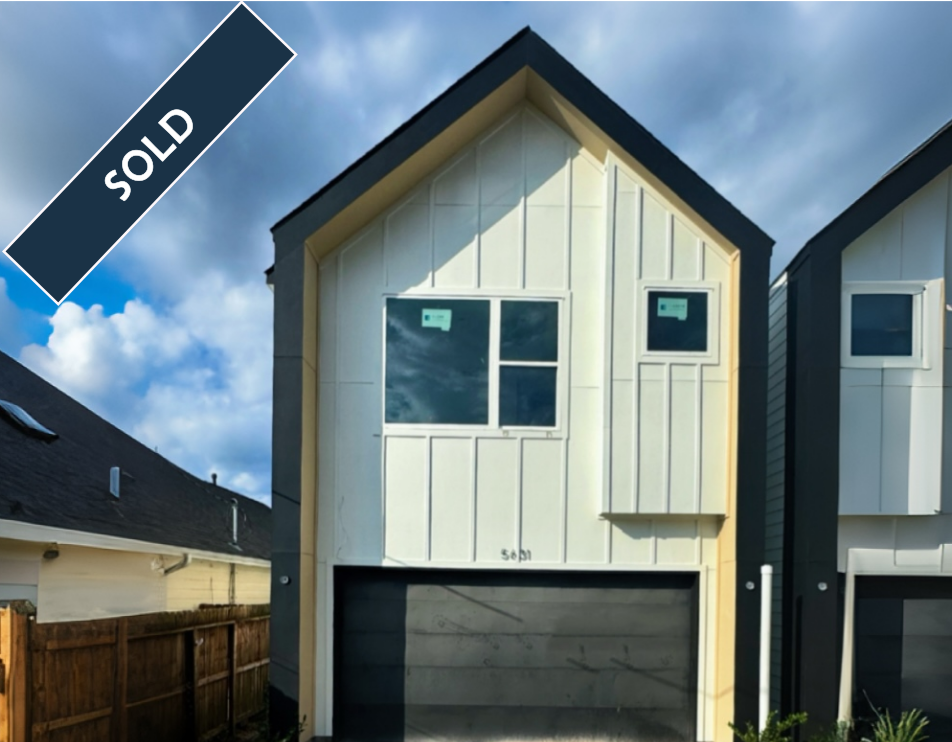 Modern two-story home with white and gray exterior, black garage door, and