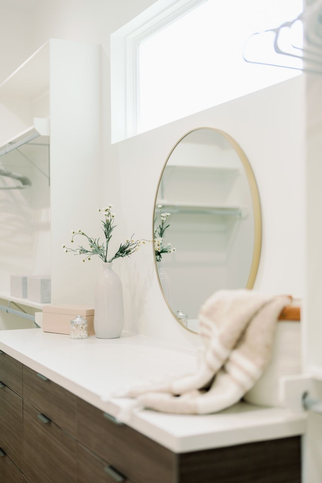 Close detail of the Driscoll vanity mirror, flowers and countertop