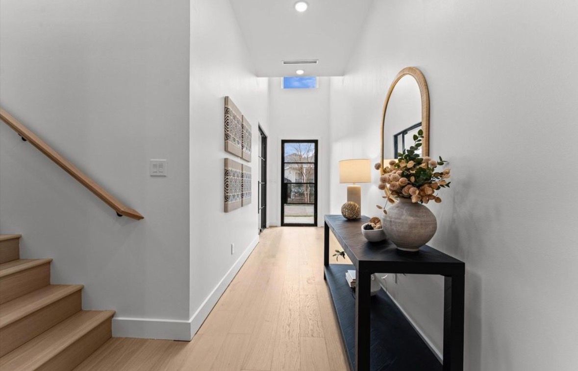 Entry area with staircase console table and modern decor accents