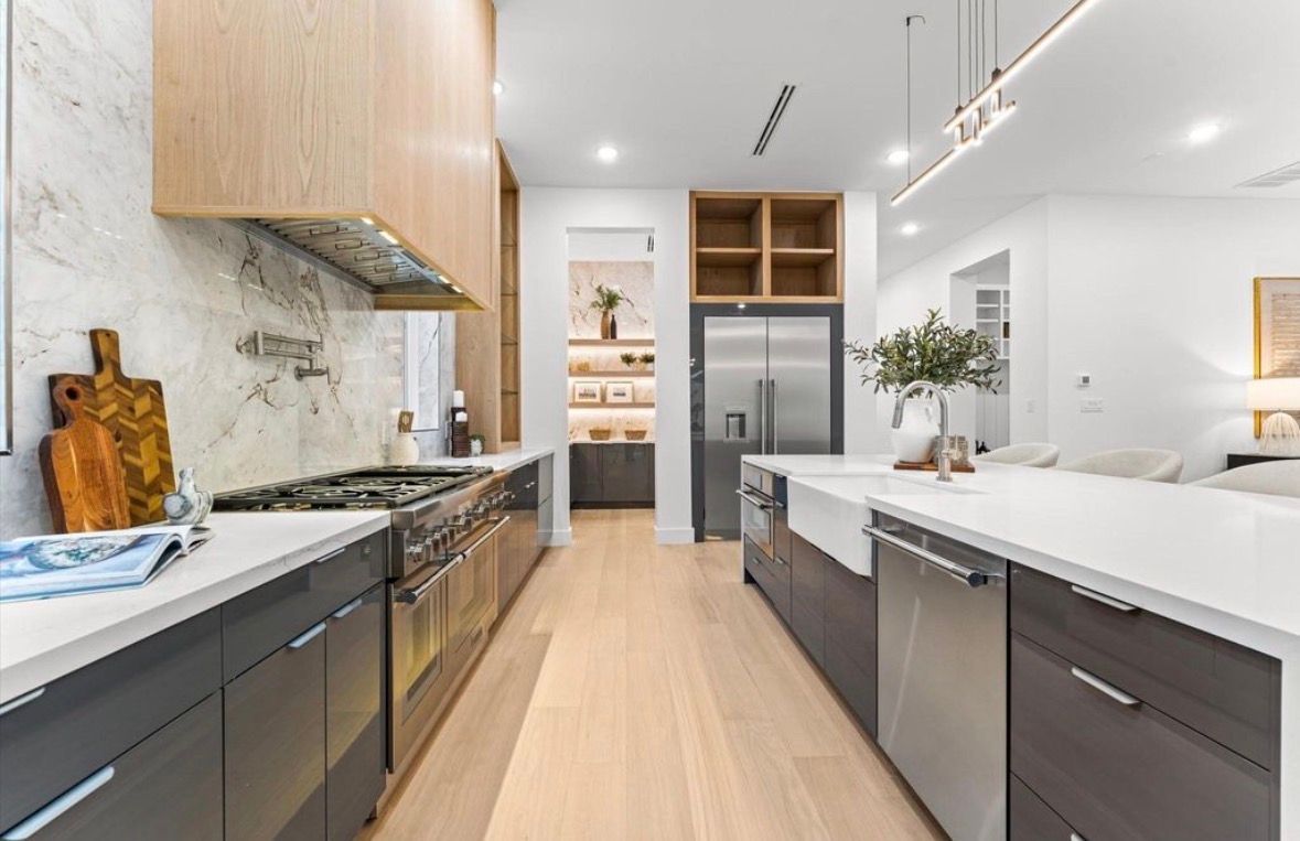 Modern kitchen with wood cabinets quartz countertops and built in appliances