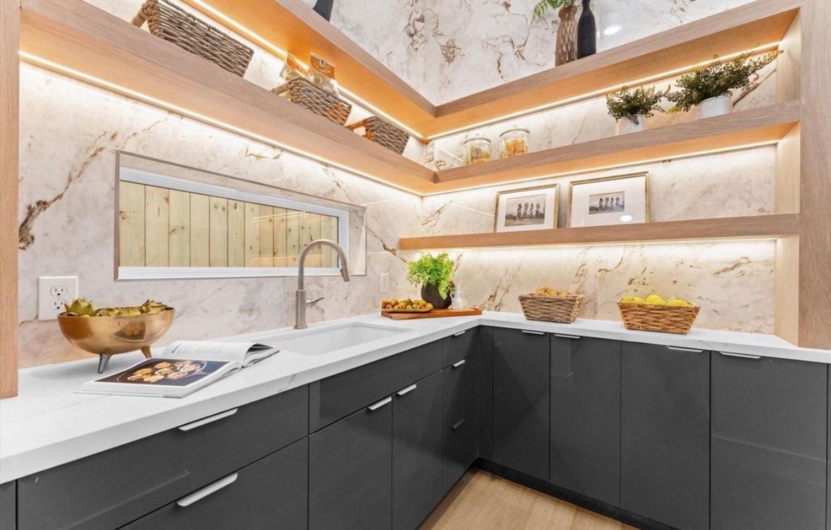 Walk in pantry with built in shelving storage and organized layout in luxury home kitchen