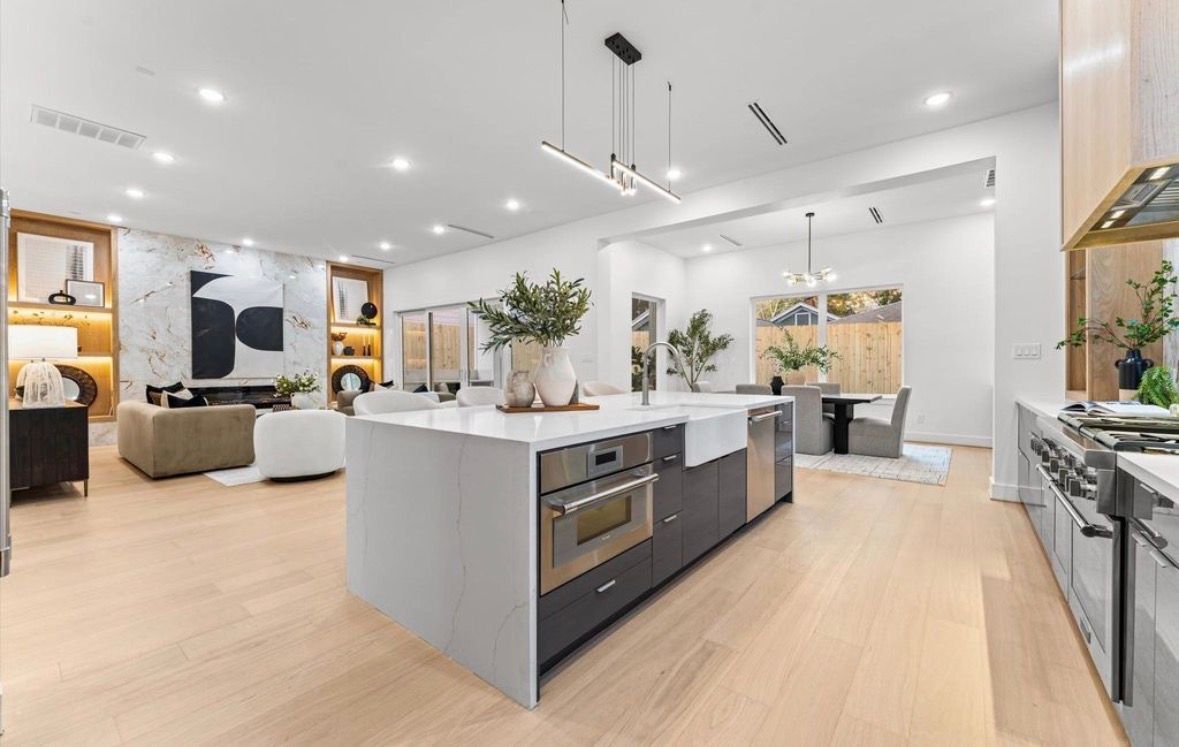 Open concept living and kitchen with large island and modern finishes in Houston home