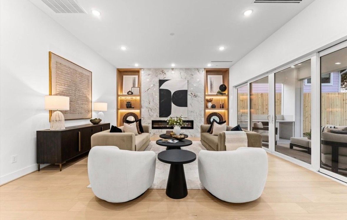 Modern living room with neutral tones curved chairs and open layout in luxury home