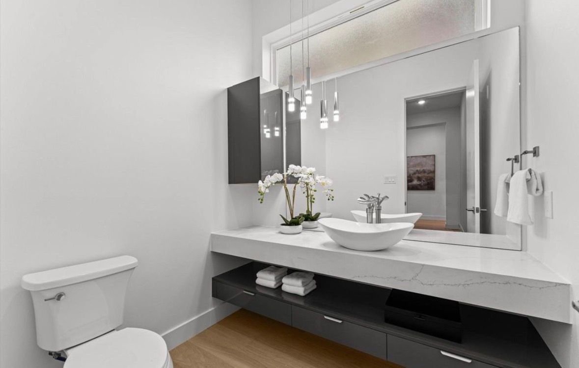 Modern powder bathroom with vessel sink floating vanity and minimalist design