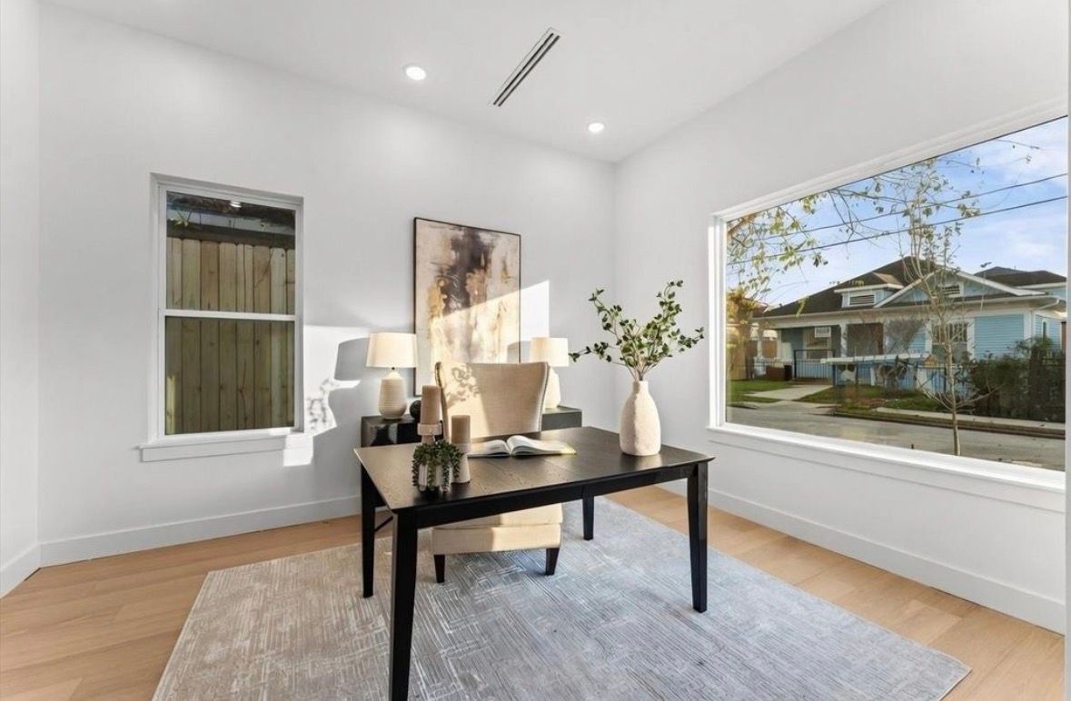 Bright office space with large window and minimalist staging in Houston home