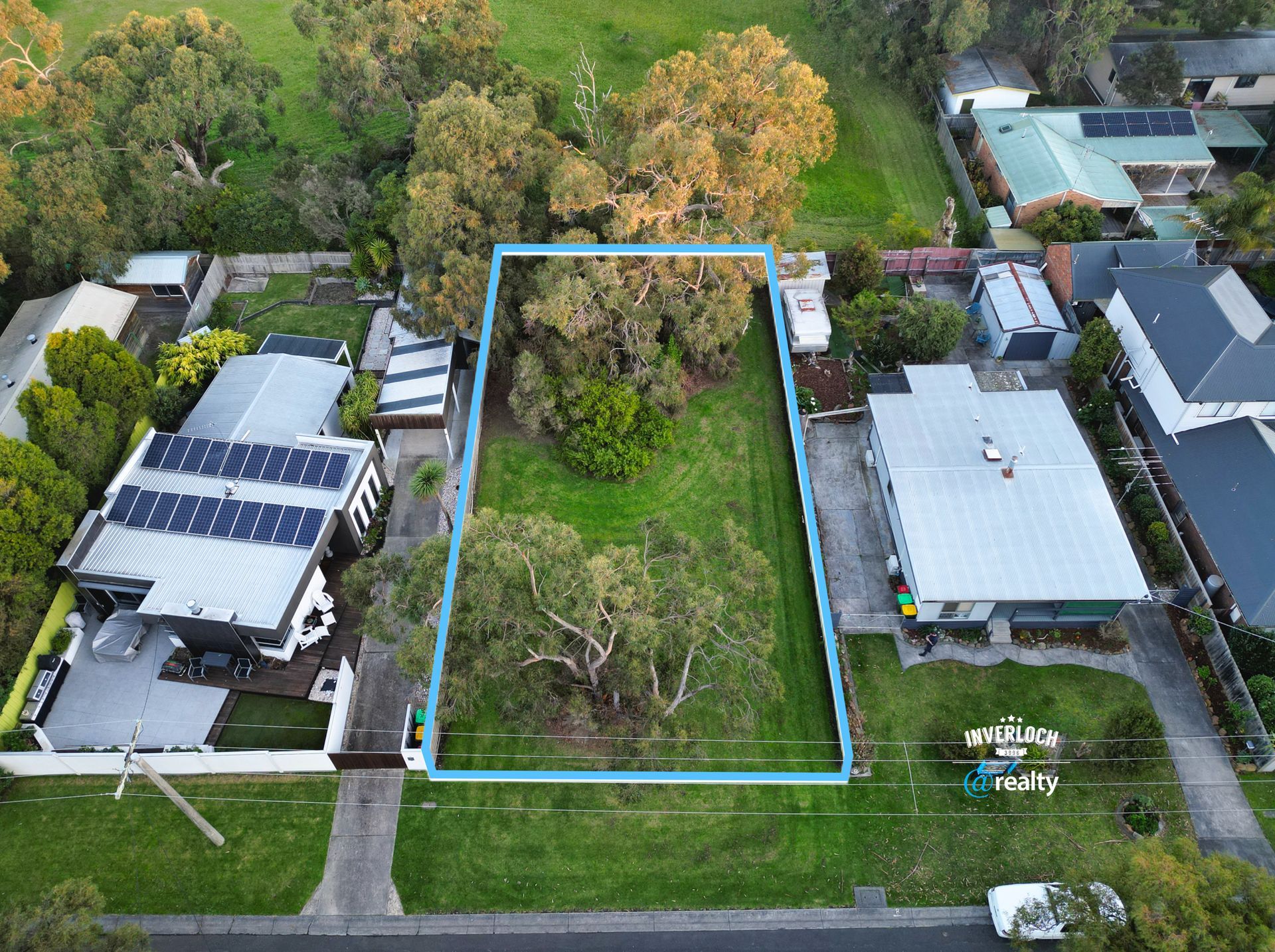 An aerial view of a residential area with houses and trees
