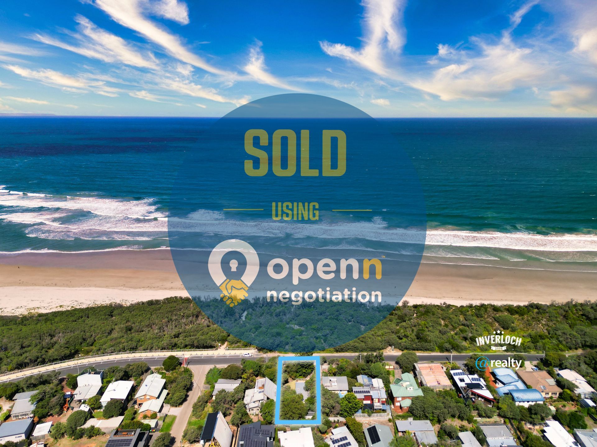 An aerial view of a beach with a sign that says sold using openn negotiation.