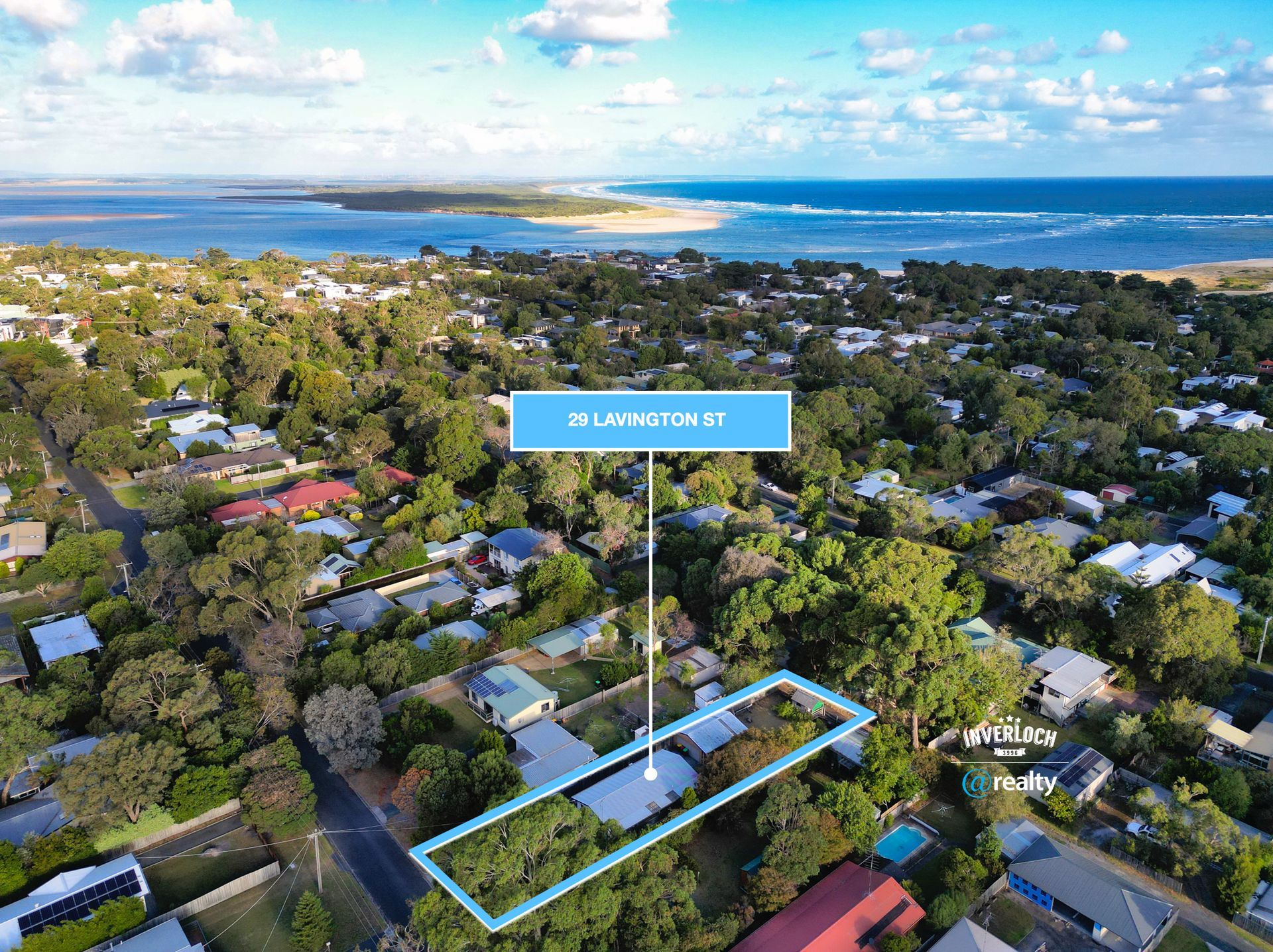 An aerial view of a residential area with a house in the middle of it.