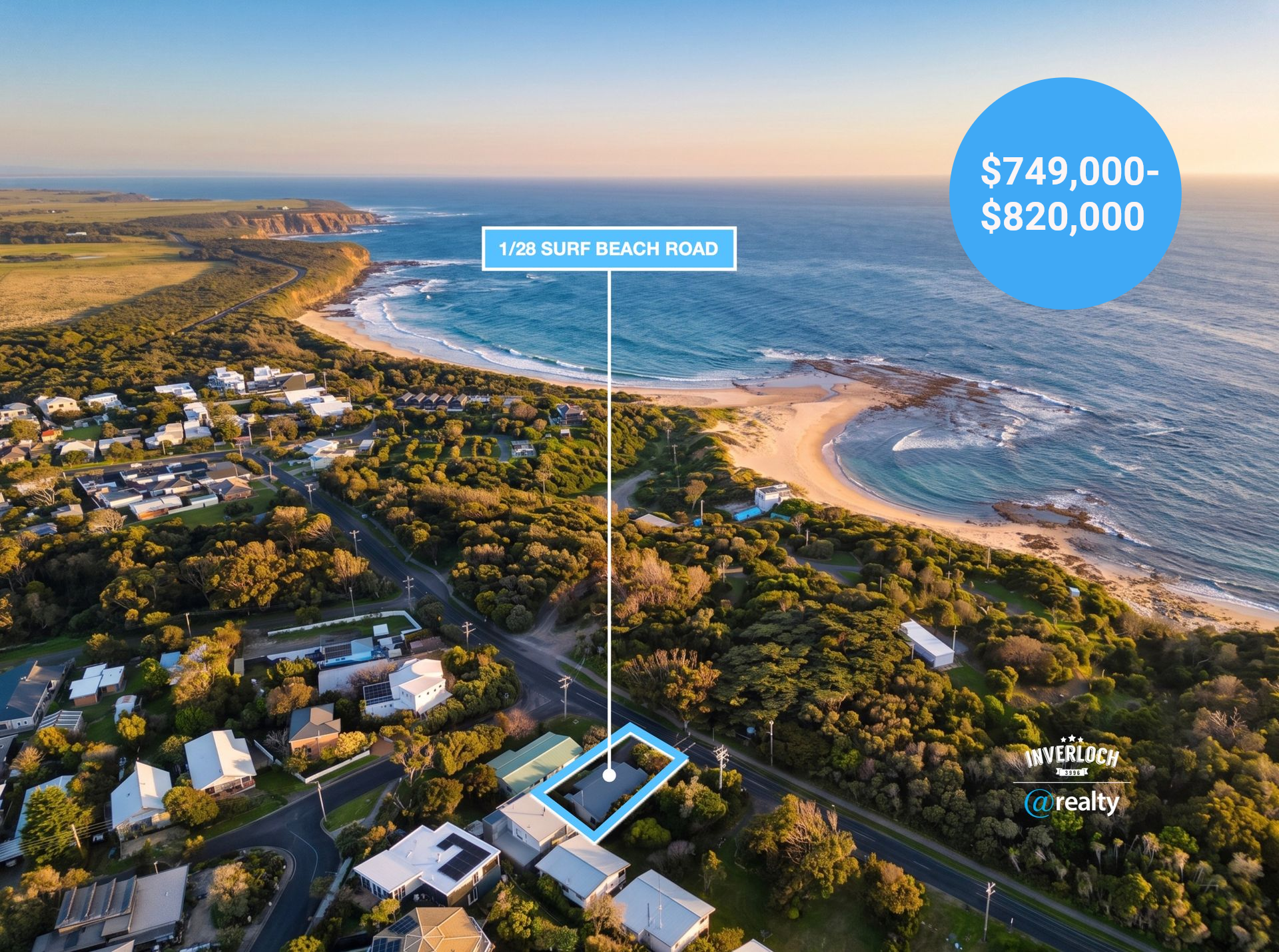 Aerial view of a coastal town with houses, trees, and a rocky shoreline beside the ocean at sunset.