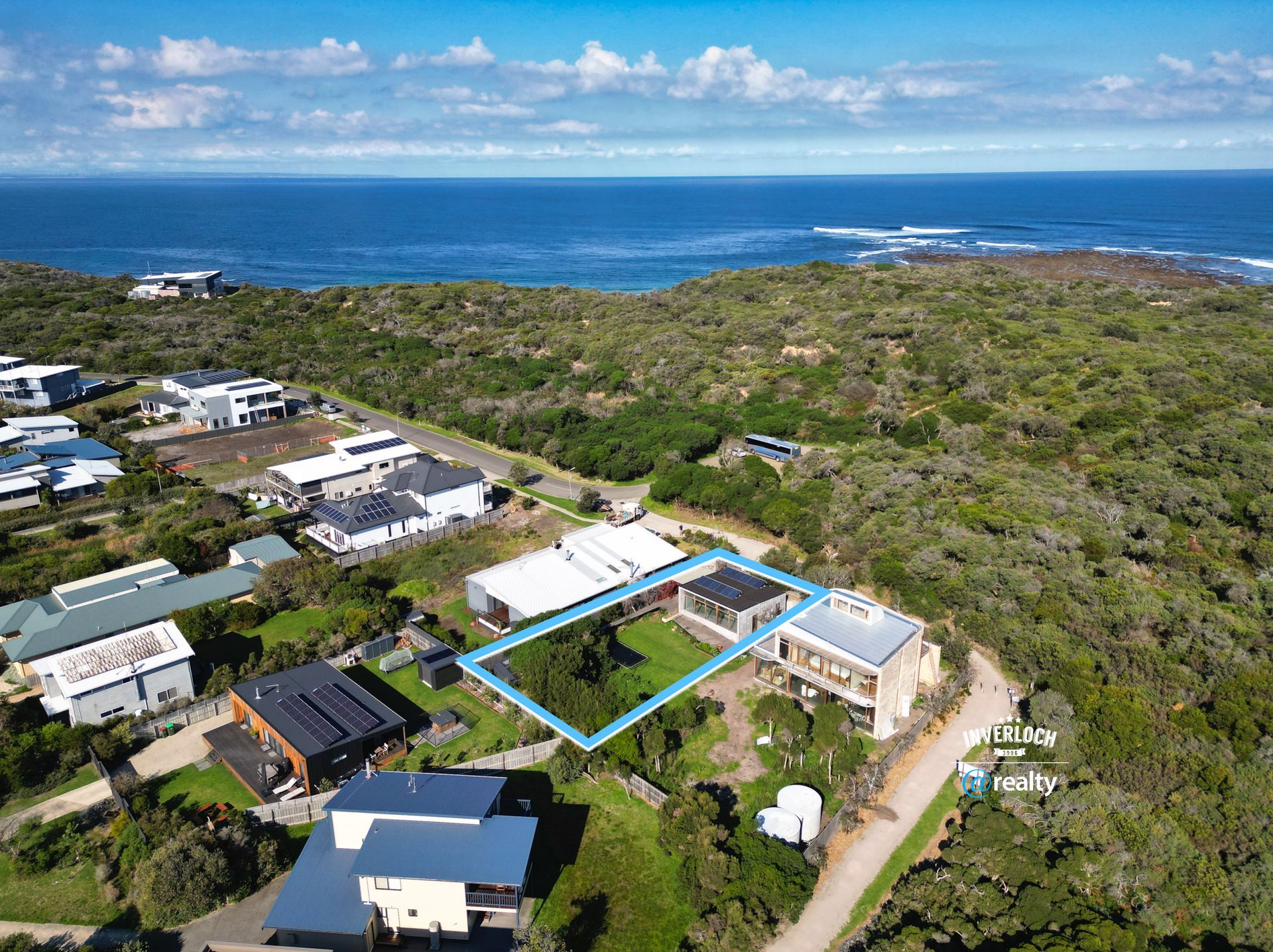 An aerial view of a residential area next to the ocean.