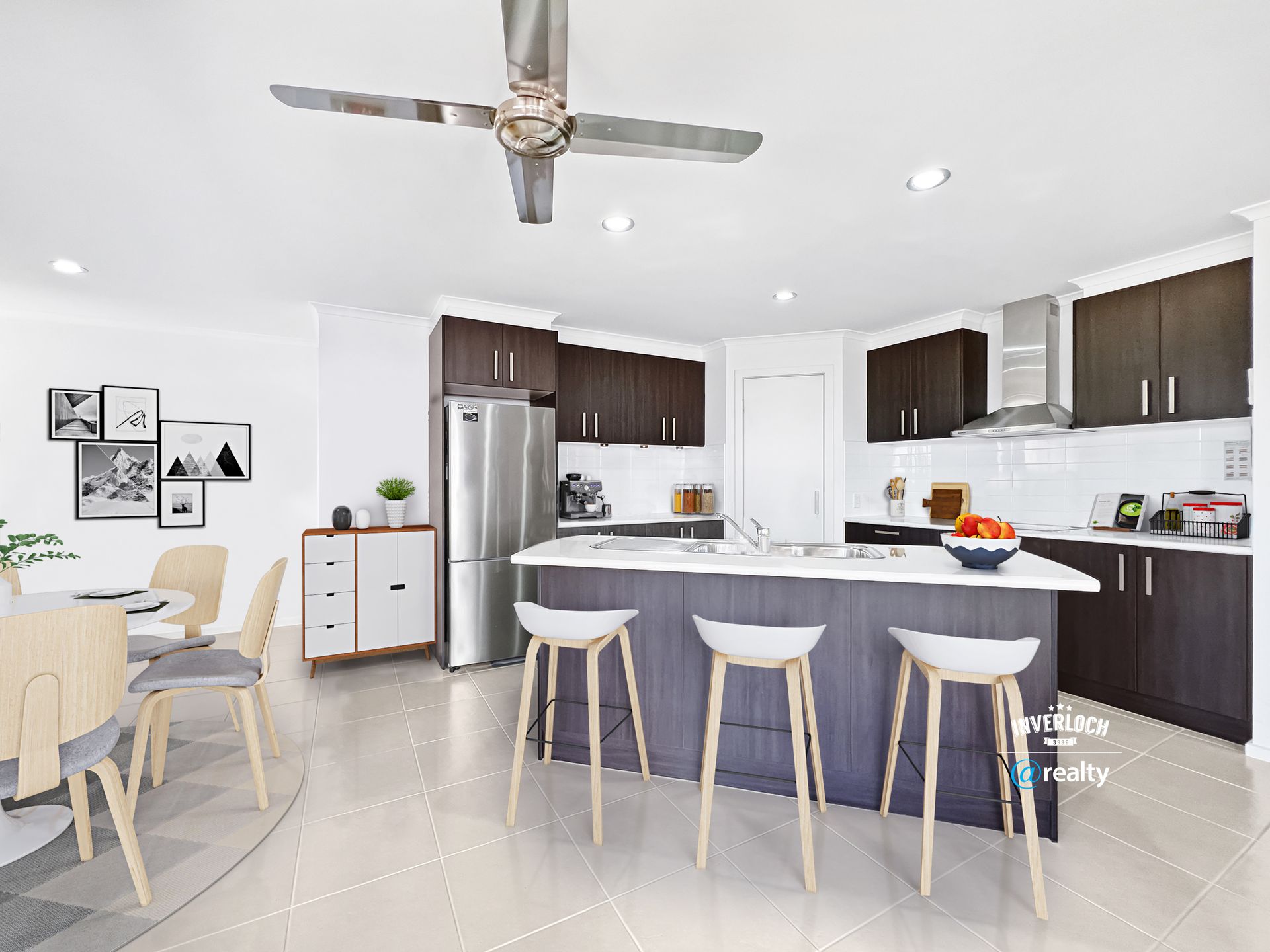A kitchen with a large island and a ceiling fan.