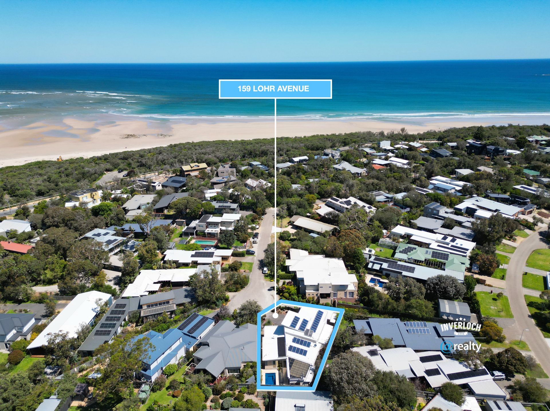 Aerial view of homes along a street leading to a beach. A house is highlighted with a label: