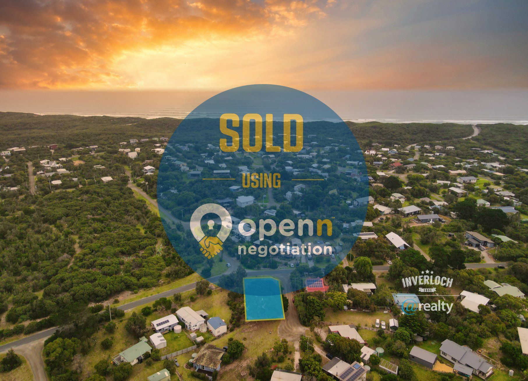 An aerial view of a residential area with a sold sign.