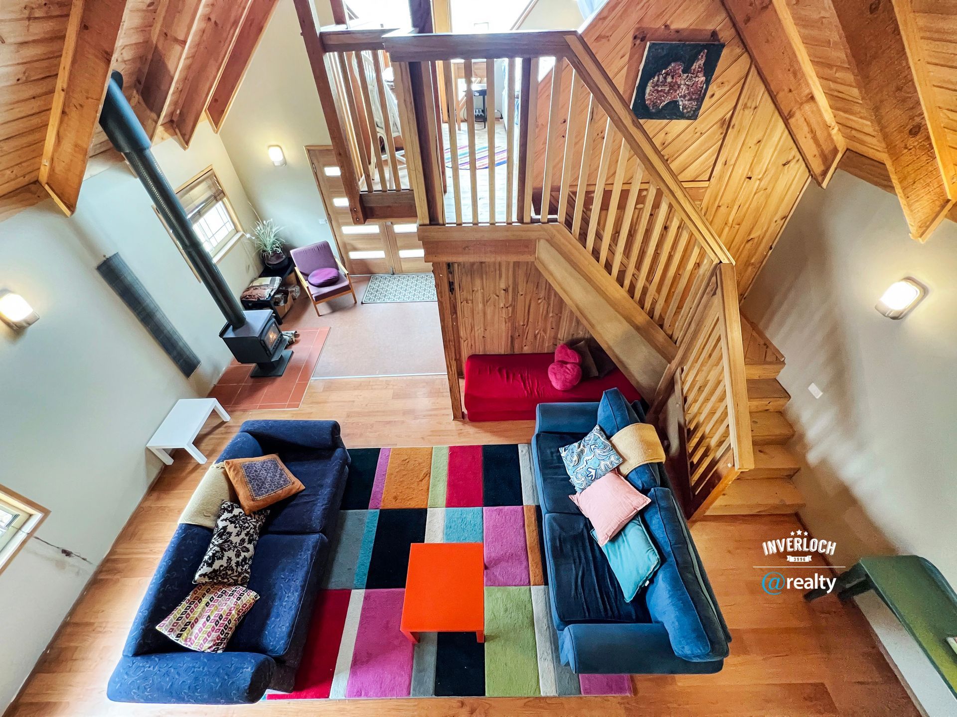 An aerial view of a living room with two couches and stairs