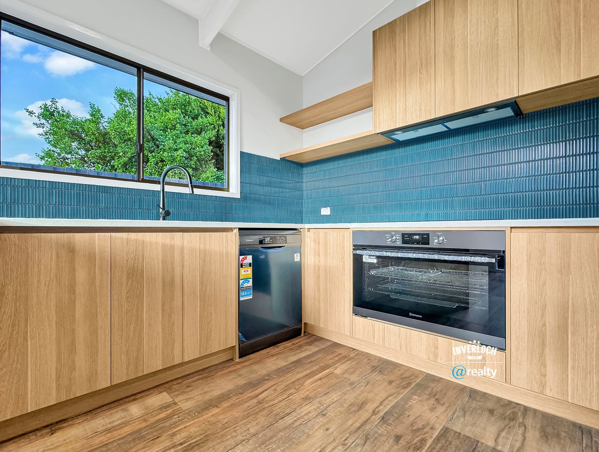 A kitchen with wooden cabinets and blue tiles.