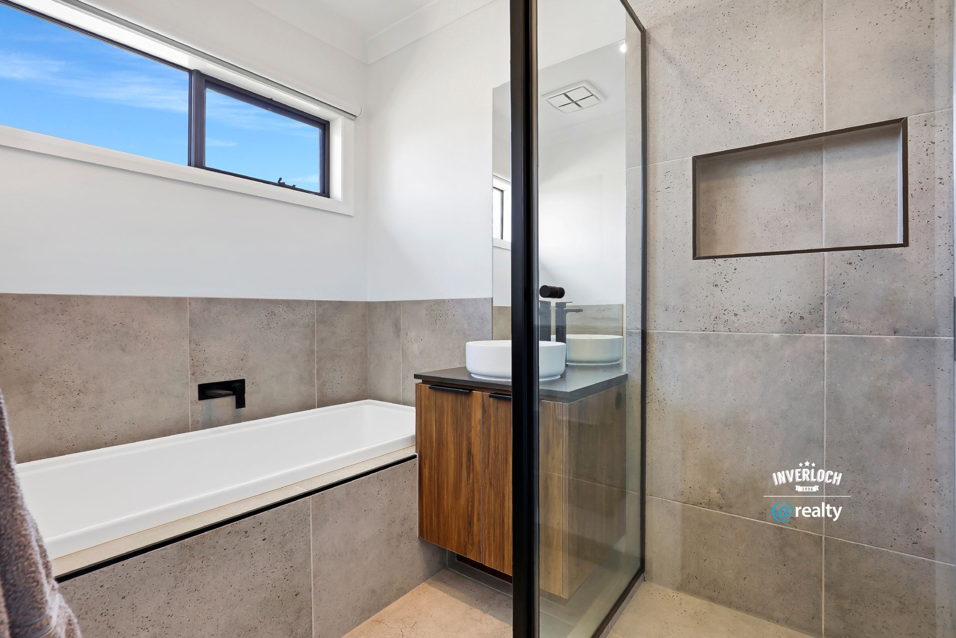 A bathroom with a bathtub , sink , and shower.