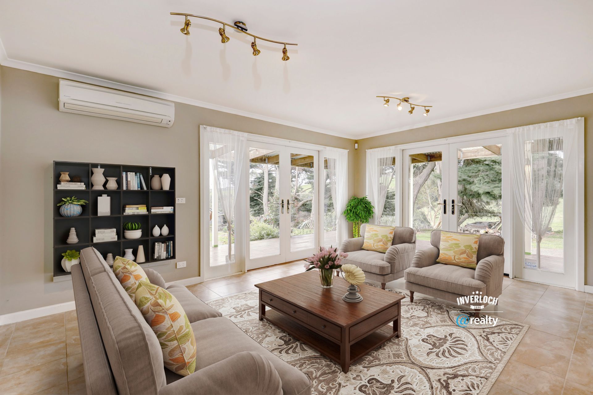 A living room with a couch , chairs , a coffee table and a bookshelf.