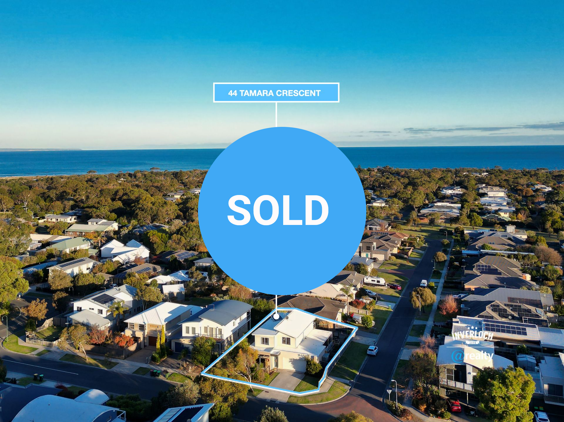 An aerial view of a residential area near the ocean