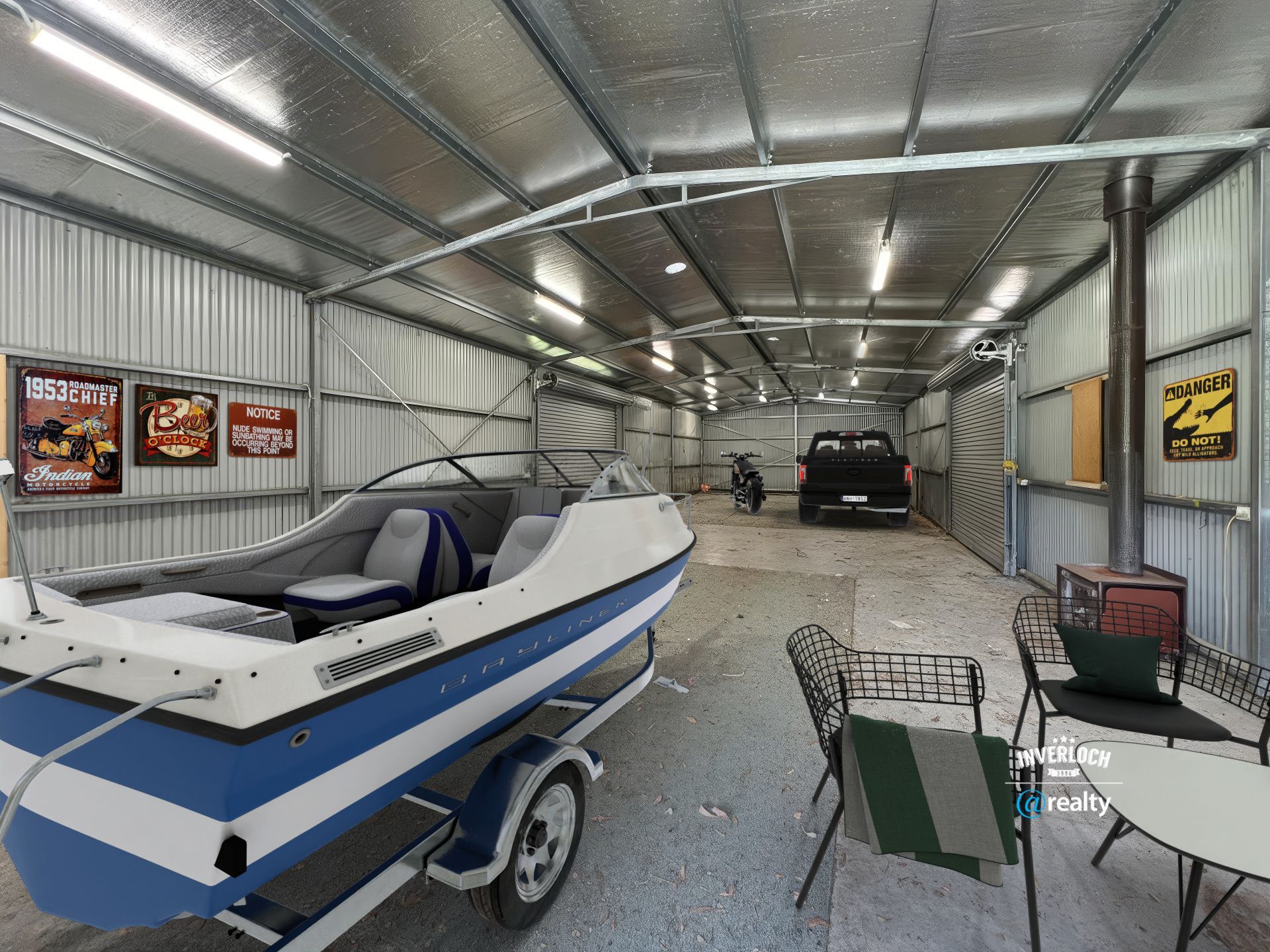 A boat is parked in a garage next to a table and chairs.
