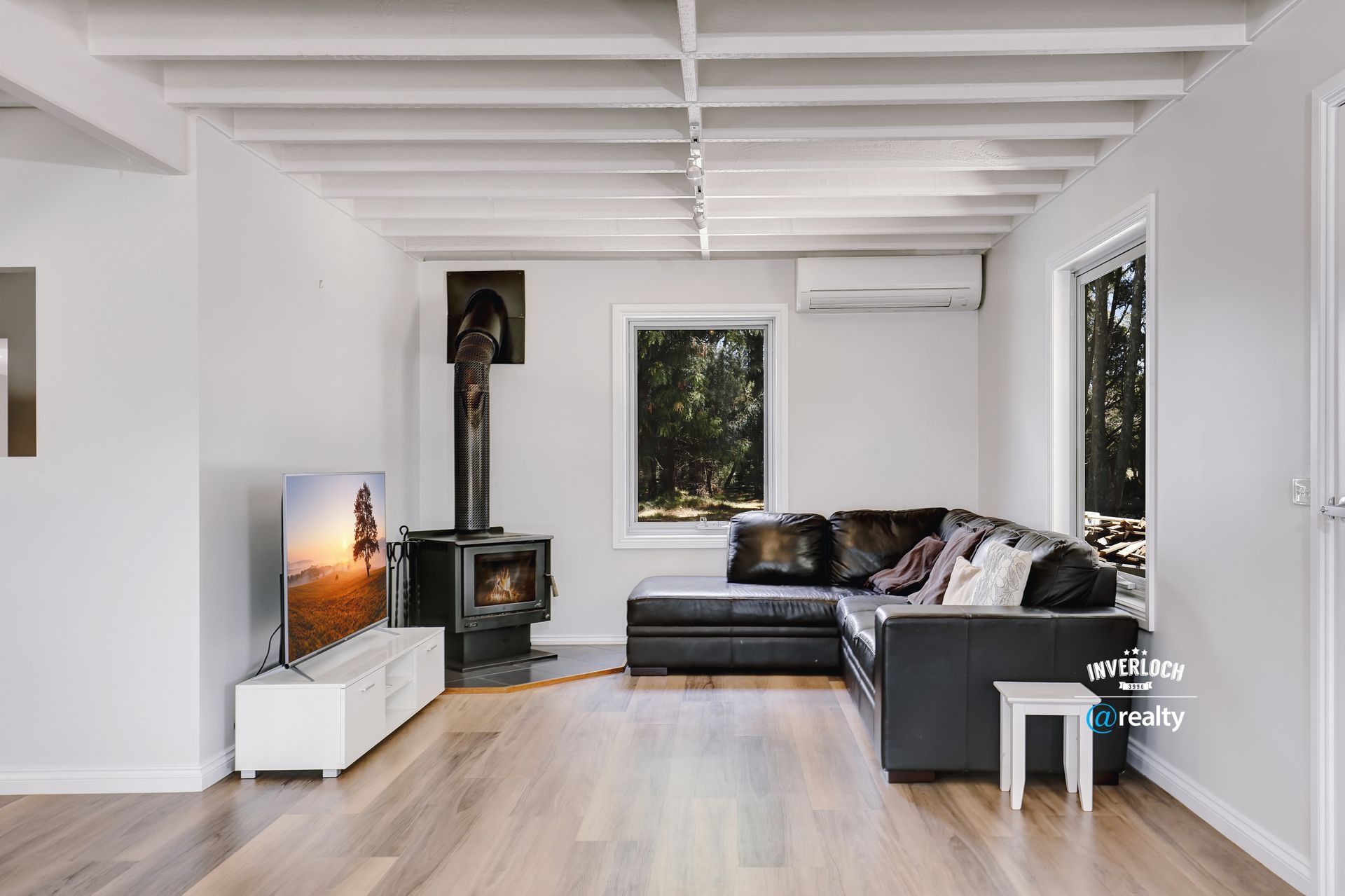 A living room with a couch , television , and fireplace.