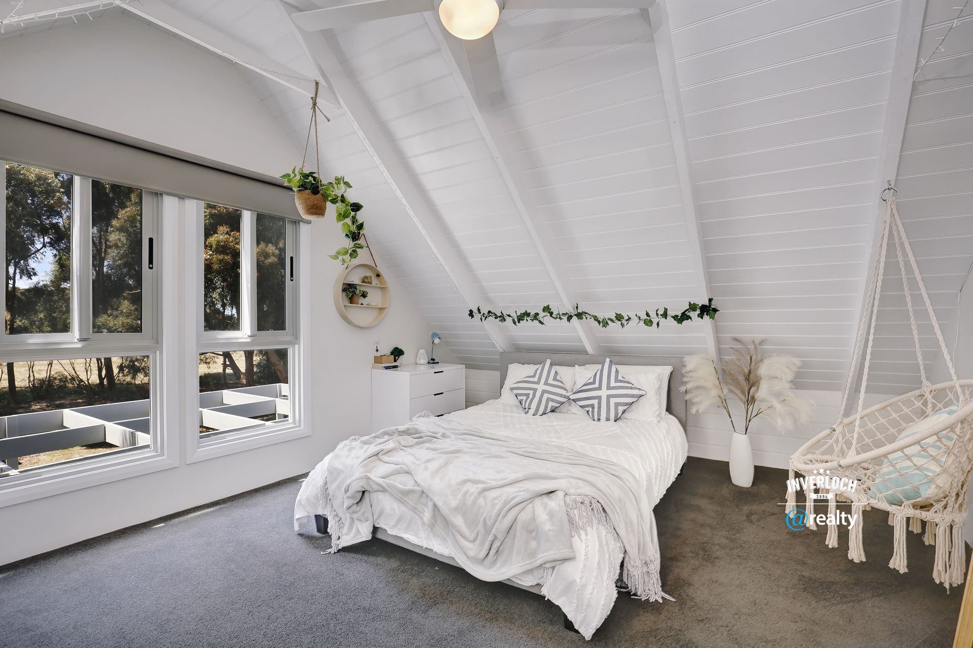 A bedroom with a bed and a hammock in it