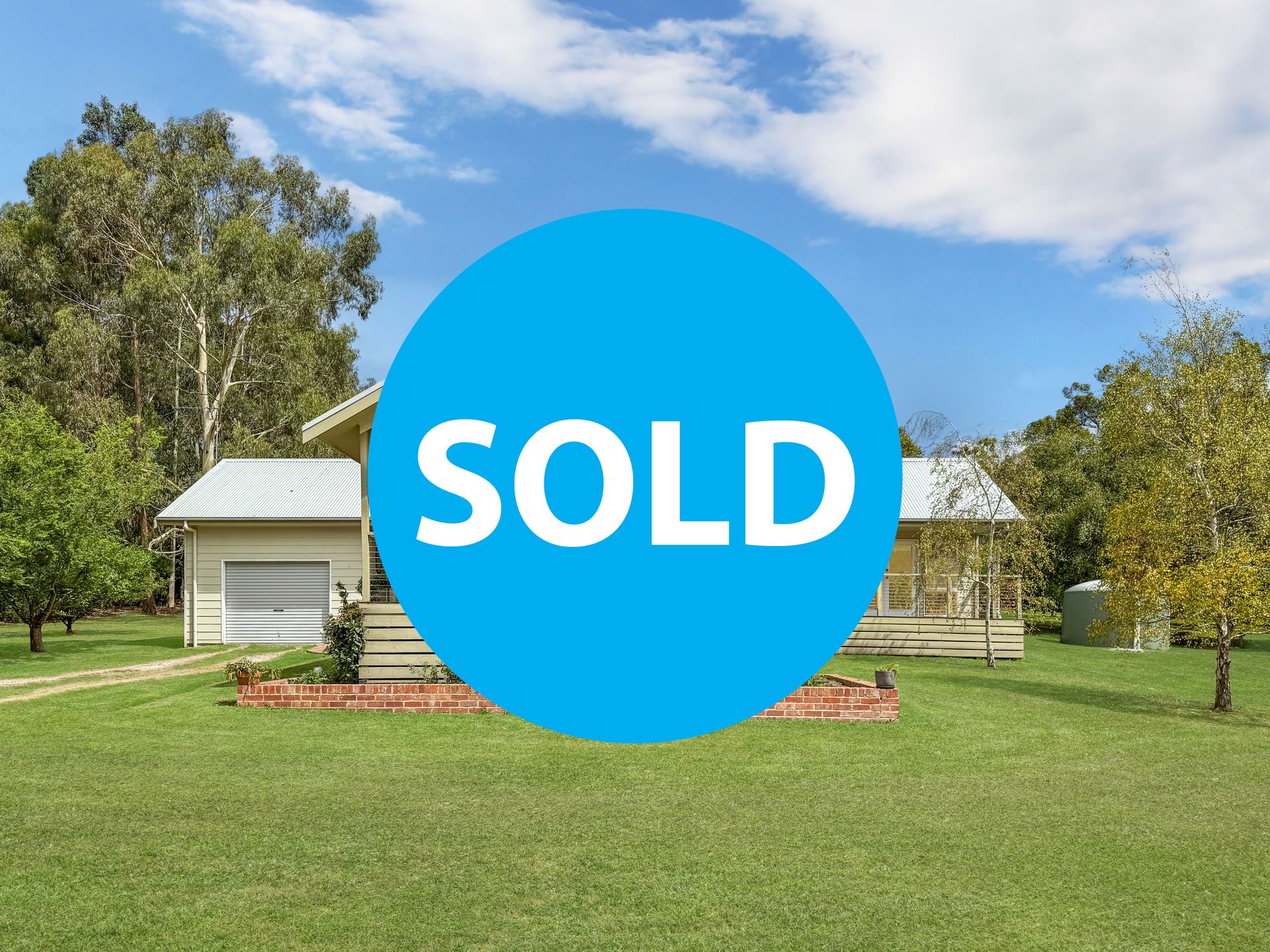 A house with a sold sign in front of it