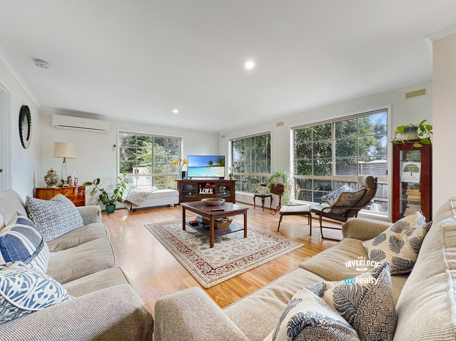 A living room filled with furniture and a television.