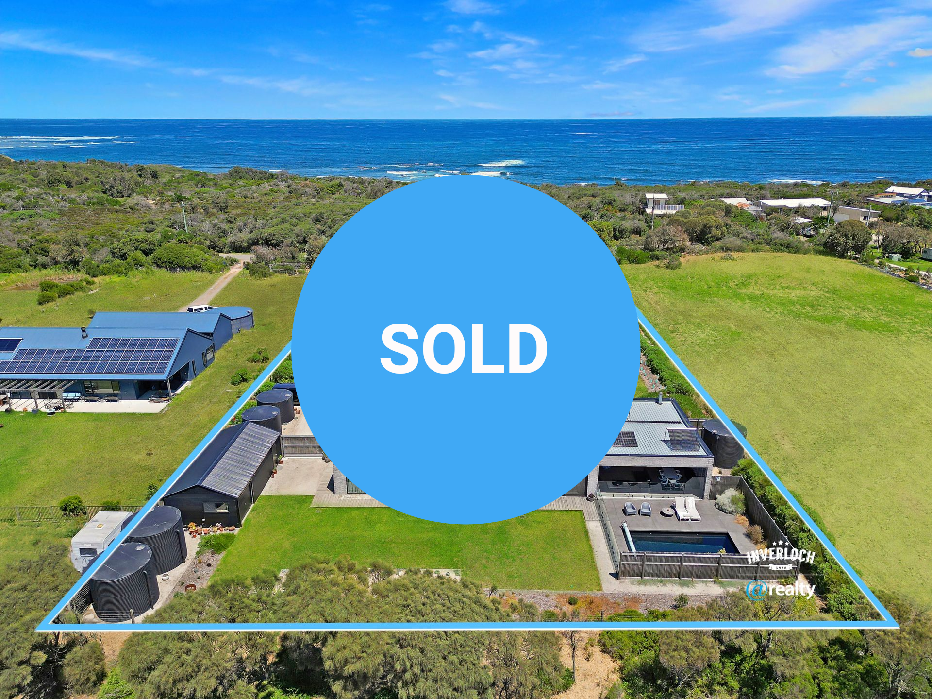 An aerial view of a large house with a view of the ocean.