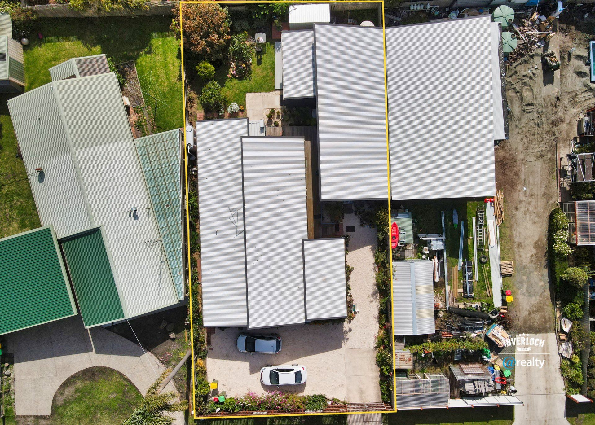 An aerial view of a house with a car parked in front of it