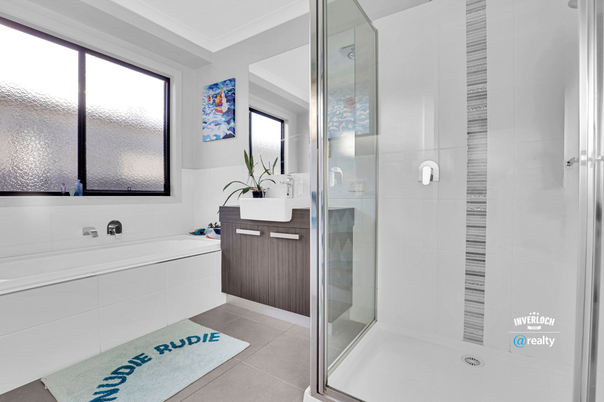 A bathroom with a bathtub , sink , and shower.