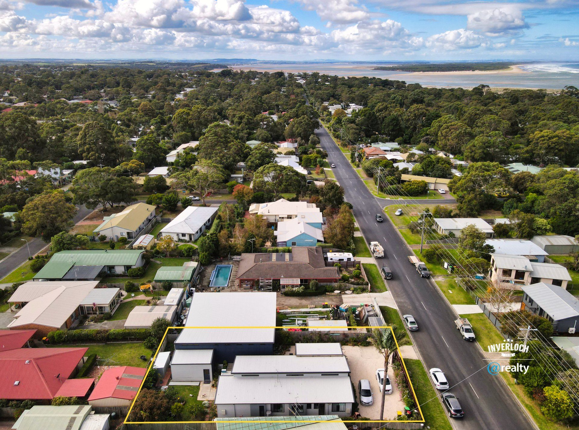 An aerial view of a residential area with a river in the background.
